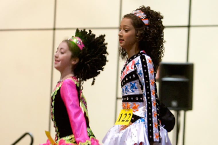 Olivia Tuma, 11, with the Peter Smith Dance School, right, and Caitlin Gallagher, 11, with the MacDade-Cara School, left, dance during their competition. (Ed Hille / Staff Photographer)