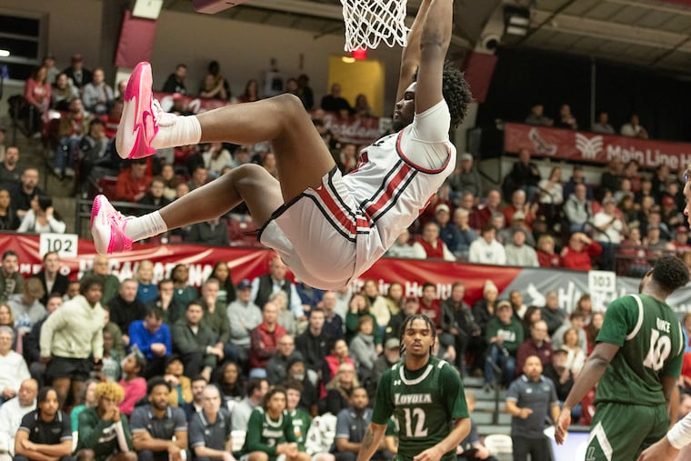 Christ Essandoko of St. Joseph's dunks against Loyola of Maryland.