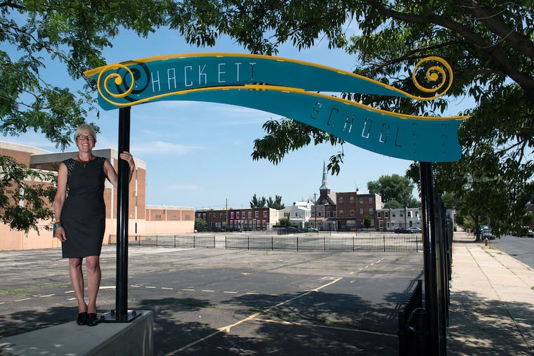 Lois Brink, 61, chief strategist for Big Sandbox, stands at the entrance to Hackett Elementary School’s future green schoolyard.