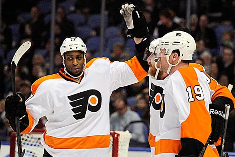 The Flyers' Wayne Simmonds celebrates with Jakub Voracek and Scott Hartnell after a goal by Voracek during the second period. (Gary Wiepert/AP)