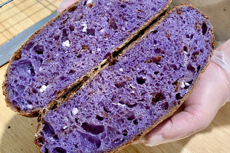 A split loaf of butterfly pea flower sourdough bread by Zach Posnan.
