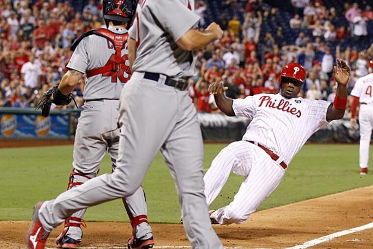 Ryan Howard slides into home plate. (Ron Cortes/Staff Photographer)
