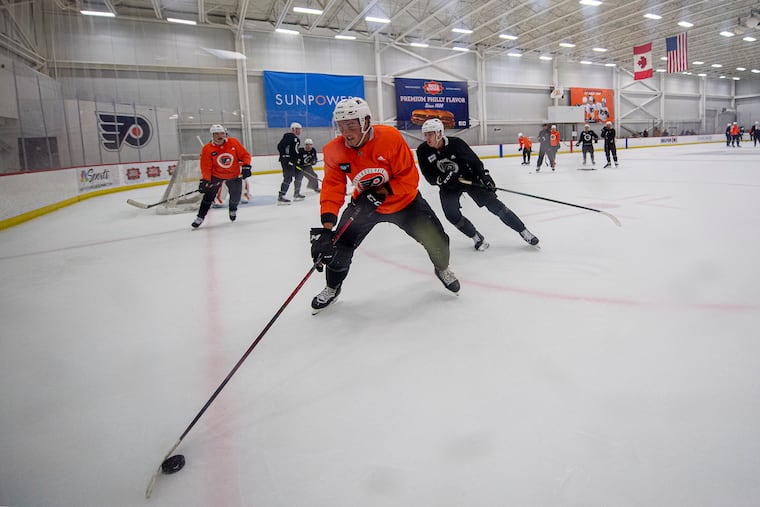 Right winger Tyson Foerster, (52) handles the puck during the first day of the Flyers' training camp in Voorhees.