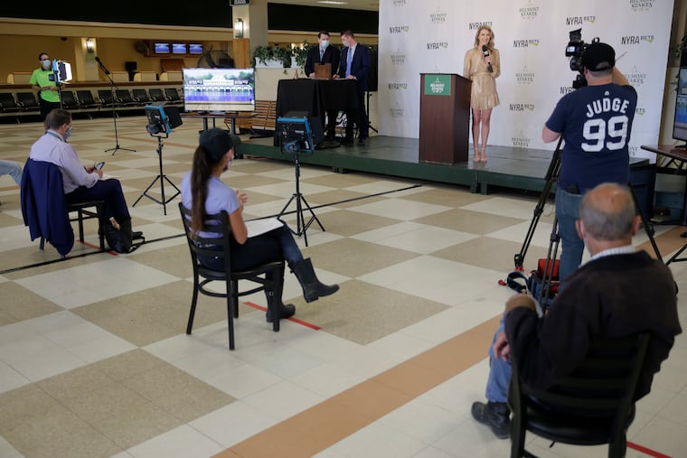 New York Racing Association analyst Acacia Courtney, center, speaks with social distancing during Wednesday's Belmont draw.