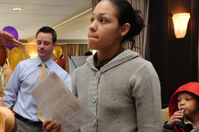 Brittany Torres of Camden talks to Emmanuel Ekeleme of Anthem Institute about becoming a student there; with her are her two children, Janelys Torres, 2, and Tymere Hollingsworth, 5. (APRIL SAUL / Staff Photographer)