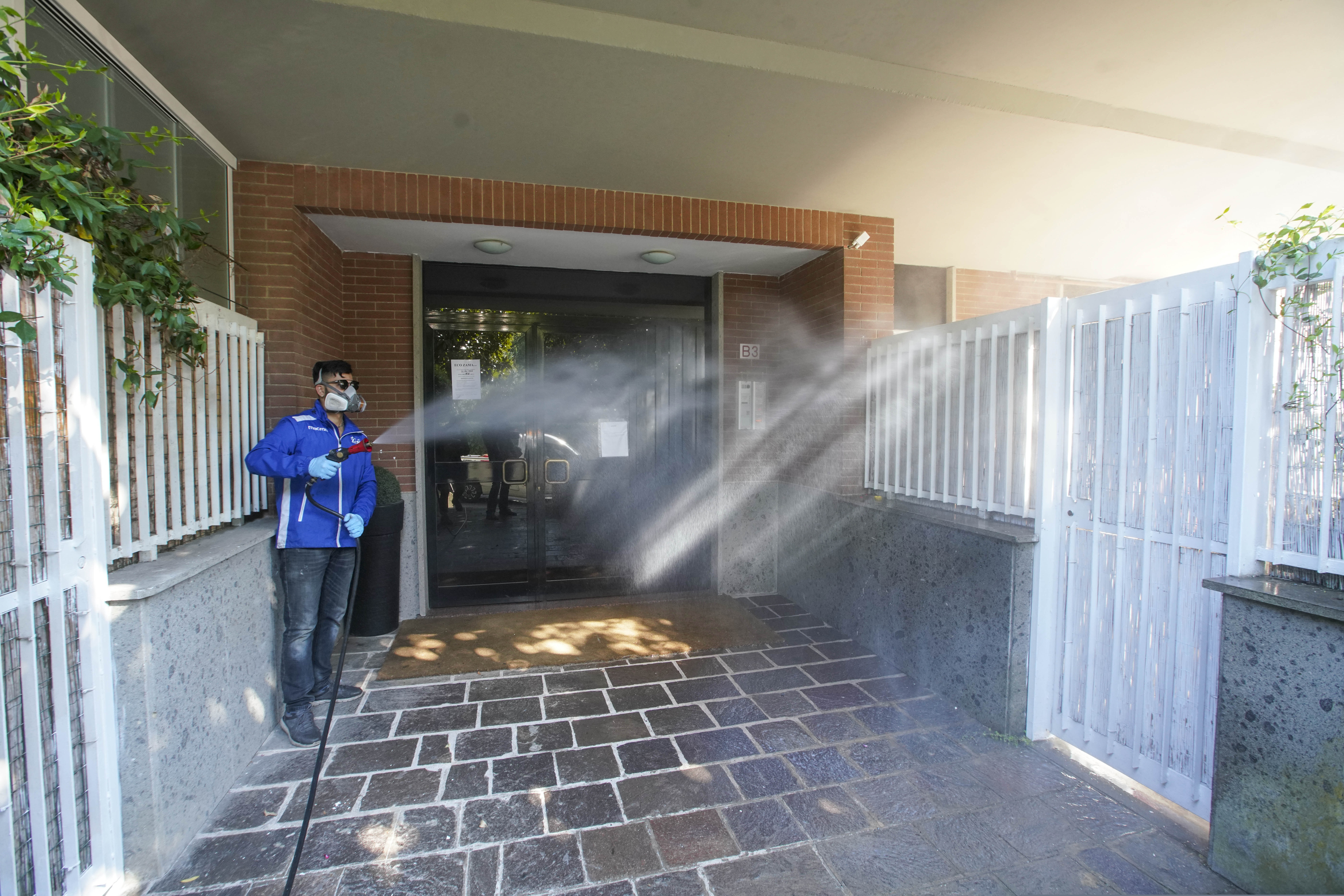 A worker sprays disinfectant in a private neighborhood in Rome on Friday.