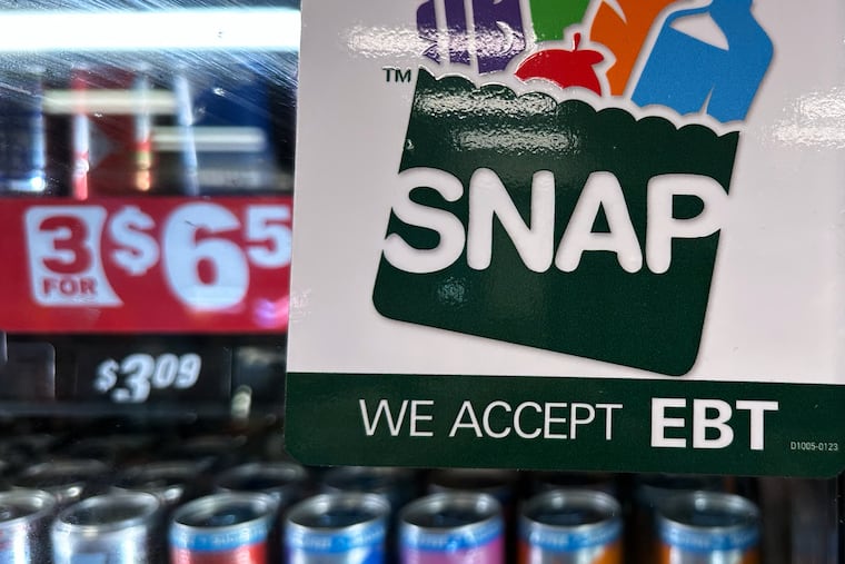 A SNAP EBT information sign is displayed at a gas station in Riverwoods, Ill., Nov. 1, 2025. Enrollment has fallen steeply as new requirements for work and documentation kick in.
