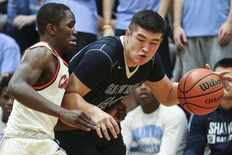 Shawnee’s Dylan Deveney drives on Cherokee’s Olarewajo Oladipo in basketball game in December.