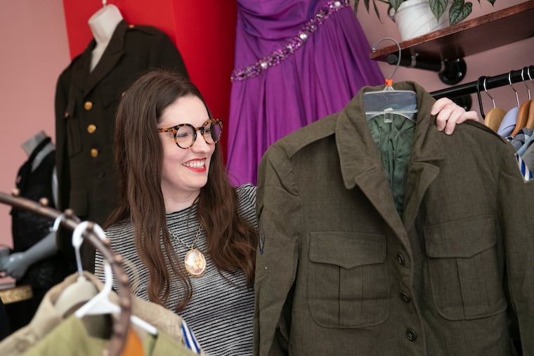Carolyn Busa lifts up vintage pieces from the rack inside her Merchantville, NJ store, Peak Secondhand, on Wednesday, June 23, 2021. Busa is a Collingswood native and has a following in the Philly and NYC stand-up comedy scenes. She was based in Brooklyn before returning to South Jersey to open her store.