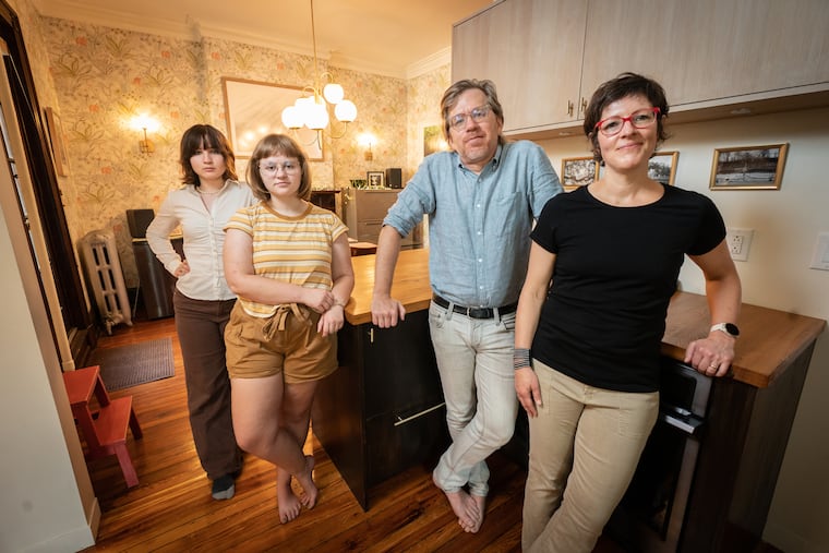 The more horizontal layout of a Queen Anne Victorian appealed to Michael Cramer and Kaela Parkhouse when they found their Powelton Village home in 2011. From lef: Amanda McCormick, family friend; Antje Cramer, their daughter; Cramer and Parkhouse in the kitchen.