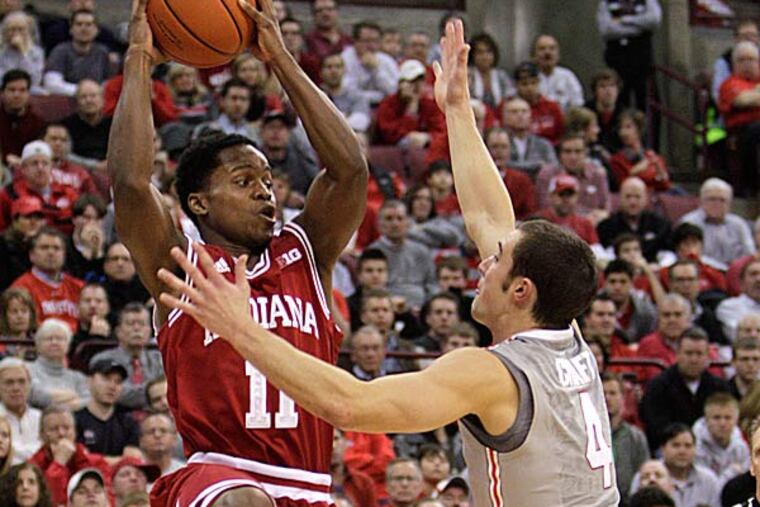 Indiana's Kevin Ferrell passes the ball as Ohio State's Aaron Craft defends during the second half. (Jay LaPrete/AP)