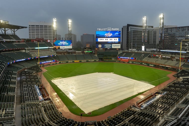 A tarp covers the infield as rain comes down at Truist Park in Atlanta after the game between the Mets and Braves was postponed on Wednesday.