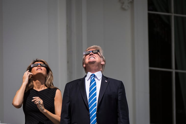 President Donald Trump and first lady Melania Trump during an eclipse in 2017.