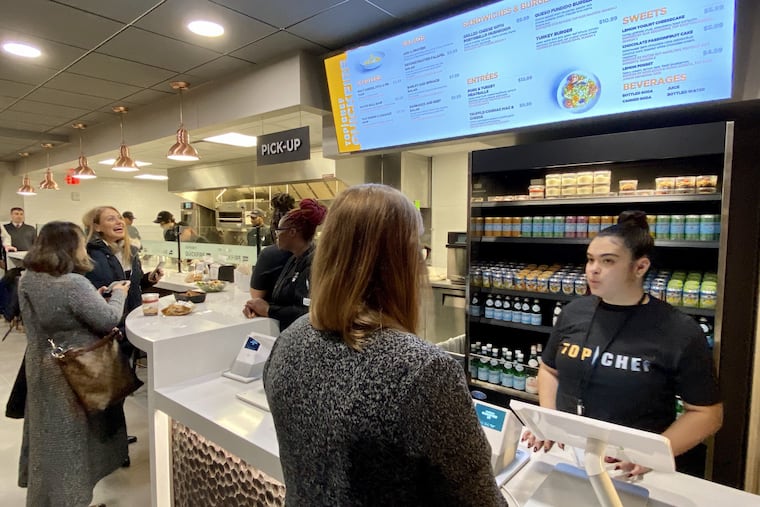 Patrons await orders at the Top Chef Quickfire counter at the Comcast Center.