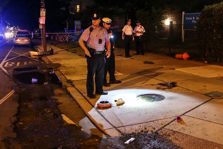 Police on the scene where a 29-year-old woman and two girls - ages 3 and 13 - were struck by a hit-and-run driver who jumped the curb and also knocked over a fire hydrant on the corner of 50th Street and Haverford Avenue, Monday, July 18, 2022.