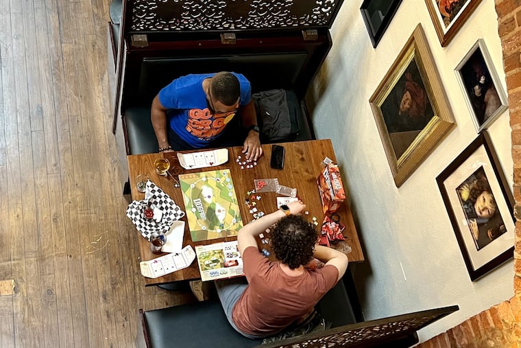 Game-players in the main room in 2024 at Queen & Rook, 123 South St., as viewed from the balcony.