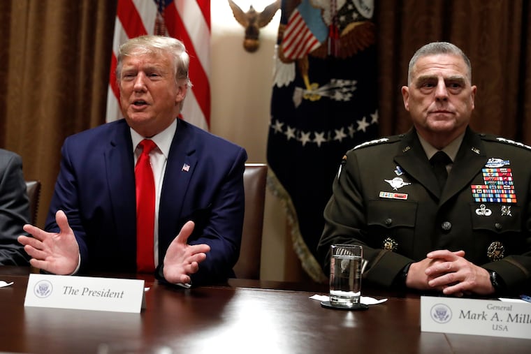 President Donald Trump (left) speaks as the chairman of the Joint Chiefs of Staff, Gen. Mark Milley, listens during a briefing with senior military leaders in the Cabinet Room at the White House in 2019. In his retirement speech last week, Milley warned against fealty to dictators, in words clearly aimed at Trump.