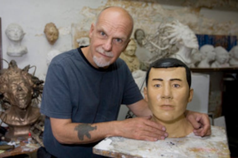 Sculptor Frank Bender, with bust he created based on remains of unidentified victim, an Asian male.