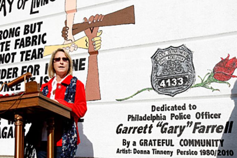 Stephanie Farrell, widow of Officer Garrett Farrell, speaks at rededication ceremony honoring her husband yesterday in Manayunk. (David Maialetti/Staff)