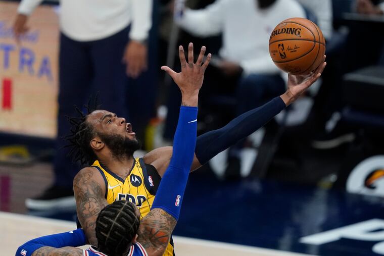 Indiana Pacers' Oshae Brissett puts up a shot against the 76ers' Mike Scott during the second half.