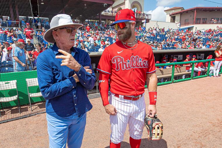 Bryce Harper, right, chats with Hall of Famer Mike Schmidt before the Phillies played their first home spring-training game Saturday at BayCare Ballpark in Clearwater, Fla.