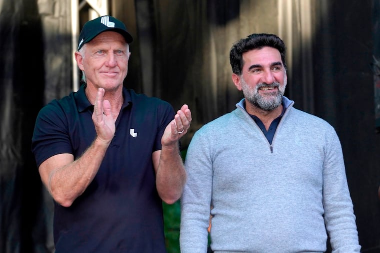 FILE - LIV Golf CEO Greg Norman, left, applauds Yasir Al-Rumayyan, Governor of Public Investment Fund of Saudi Arabia, at the LIV Golf Invitational-Chicago tournament Sept. 18, 2022, in Sugar Hill, Ill.