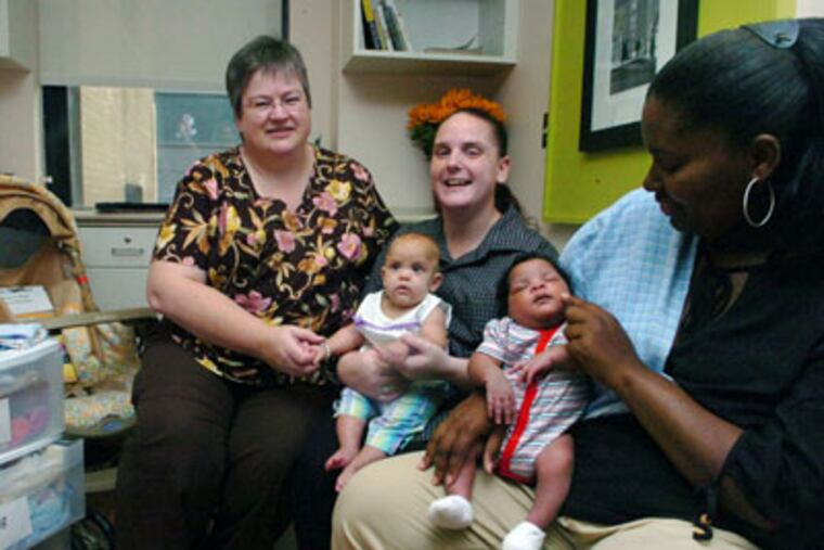 Nurse Pat Pearlman, Nancy Eisenhower, with daughter Nia Eisenhower, 8 months old, and Elizabeth Wilson with son Eli Wilson, 2 weeks old, at Cooper University Hospital. (Sarah J.Glover/Inquirer)