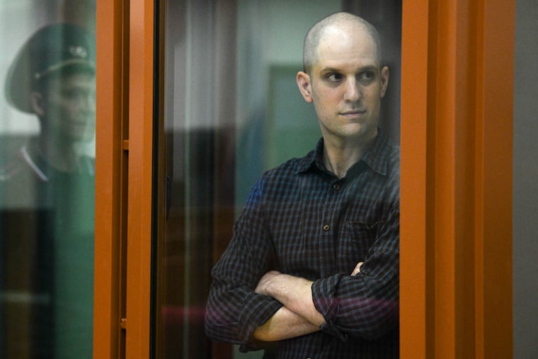 Wall Street Journal reporter Evan Gershkovich stands in a glass cage in a courtroom in Yekaterinburg, Russia, in June.