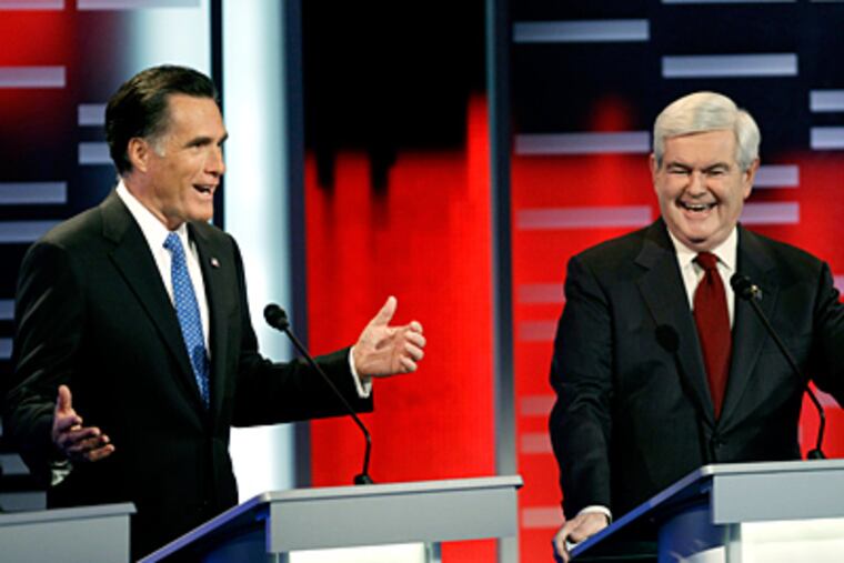 During the GOP presidential debate in Iowa, former Massachusetts Gov. Mitt Romney and former House Speaker Newt Gingrich trade remarks. The state’s caucuses are in early January. (Charlie Neibergall / Associated Press)