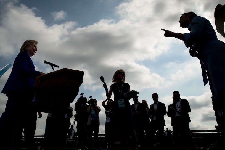 Hillary Clinton smiles as a reporter asks her a question before she boards her planeat Westchester County Airport in White Plains, N.Y.