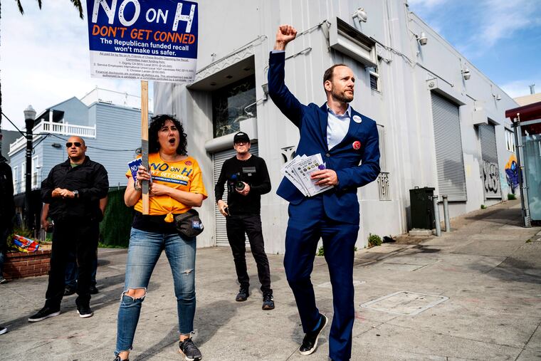 San Francisco District Attorney Chesa Boudin (right), shown campaigning on Tuesday.