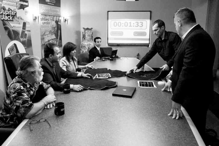Inventors Rick Vanvelsor (second from right) of Boonton, N.J., and Jim Desimone (right) of Cranford, N.J., presented their device, the "Lapkin," in 2009 at Telebrands.