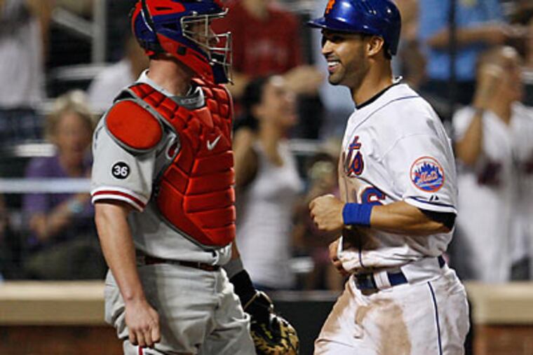 Brian Schneider (left) started at catcher for Carlos Ruiz on Wednesday. (Kathy Willens/AP)