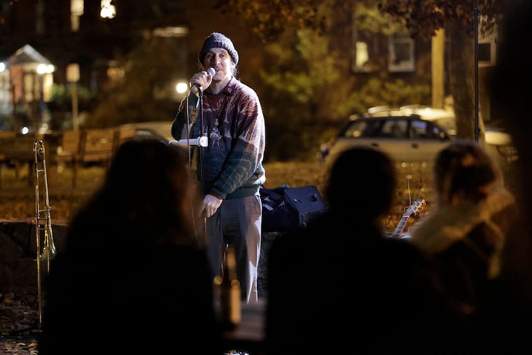 Andrew Galati — a cofounder of the West Philly Open Mic — takes the mic at Clark Park before the weekly Thursday get-together, where performers of all ages and disciplines share their art.