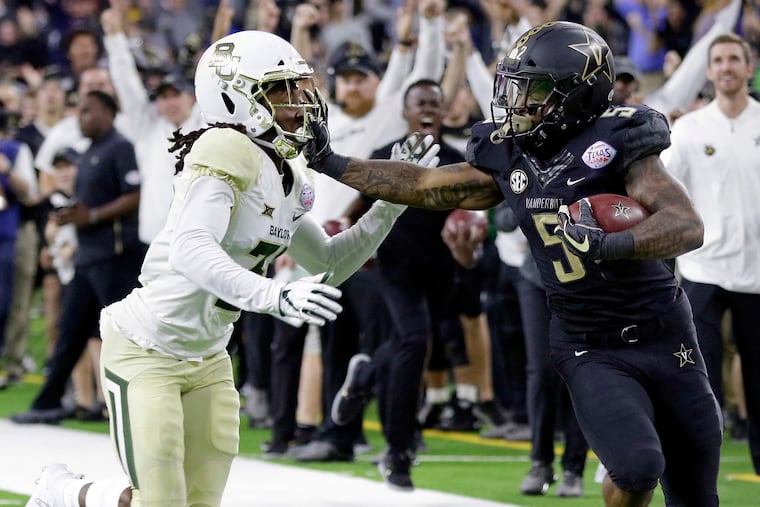 Harrison Hand (left), then with Baylor, chasing Vanderbilt running back Ke'Shawn Vaughn. Hand hopes to play for Temple this season.