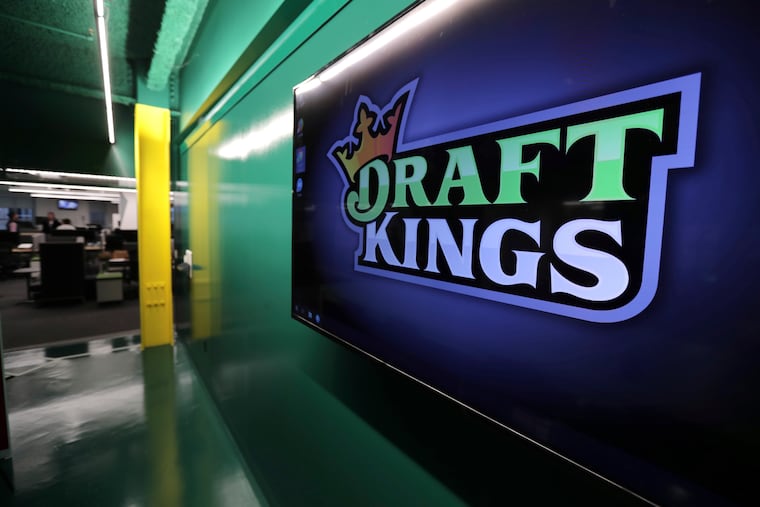 In this May 2, 2019, file photo, the DraftKings logo is displayed at the sports betting company headquarters in Boston.