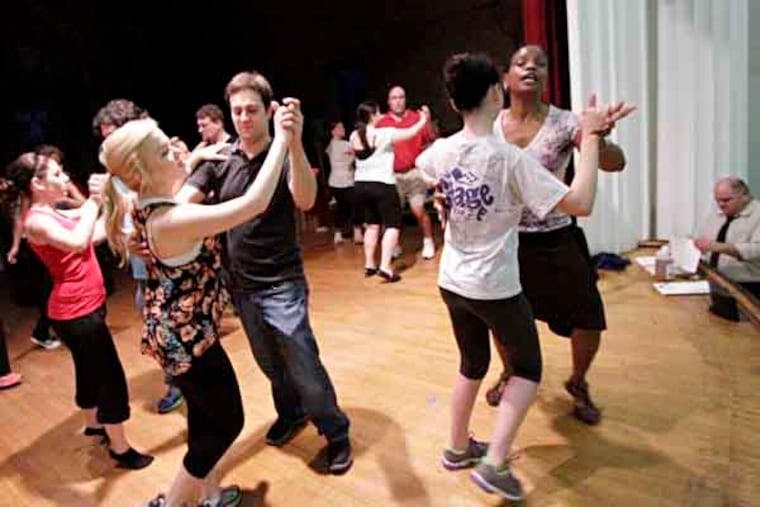 As director Ben DeFusco works at bottom right of photo, choreographer Renee Liciaga (2nd from right) teaches the waltz during a rehearsal of "The Kings Road" at the Haddon Fortnightly on Aug. 28, 2013. "The King's Road," with a cast of over 50 from all over South Jersey, returns to Haddonfield. The play recounts the storied history of the borough -- particularly the town's role in the state's abolition of slavery -- and will be performed in the Fortnightly, a building with its own colorful past. ( ELIZABETH ROBERTSON / Staff Photographer )