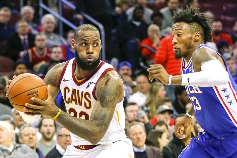 Sixers forward Robert Covington defends Cavaliers forward LeBron James on Monday, Nov. 27.