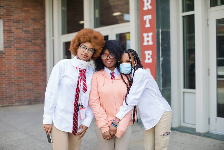 Northeast High School students (from left) Sylvie Deslouches, Harmony-Spirit Morrison, and Loviena Louiger are photographed during Afro Day outside their school on April 14, 2023. Students at Northeast hosted Afro Day to celebrate natural hair and all it means, personally and culturally.
