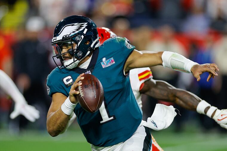 Eagles quarterback Jalen Hurts runs with the football against the Kansas City Chiefs during Super Bowl LVII.