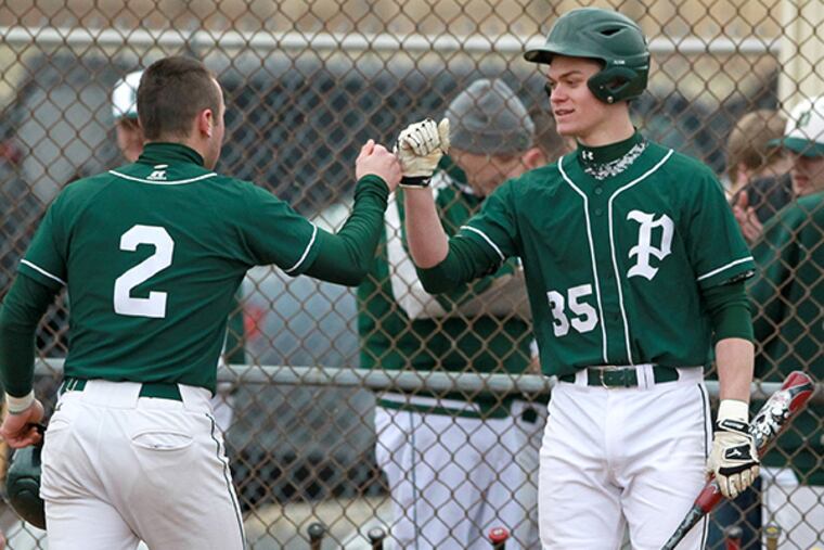 Dan Long, left, of Pennridge is congratulated by teammate Tommy
Nuneviller, right, after he scored on a hit by David Tatoian in the
4th inning against Central Bucks East in a Suburban One League
baseball game on March 30, 2015. (Charles Fox/Staff Photographer)