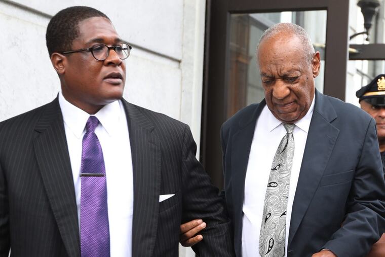 Bill Cosby leaves Montgomery County Courthouse with his spokesman, Andrew Wyatt, after a mistrial was declared Saturday.