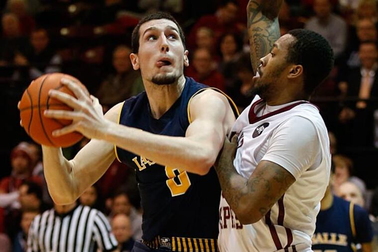 La Salle's Steve Zack looks to shoot the basketball over Saint Joseph's Isaiah Miles. (Yong Kim/Staff Photographer)