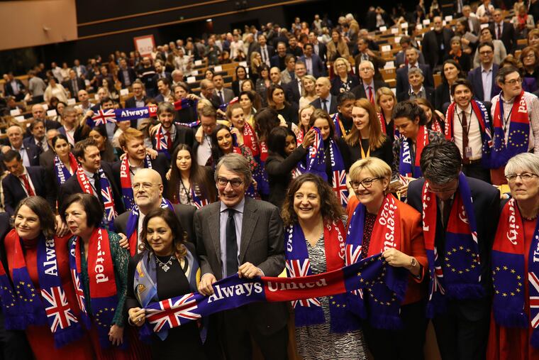 European Parliament President David Sassoli, center, stands with other British MEP's and members of the political group Socialist and Democrats as they participate in a ceremony prior to the vote on the UK's withdrawal from the EU at the European Parliament in Brussels.