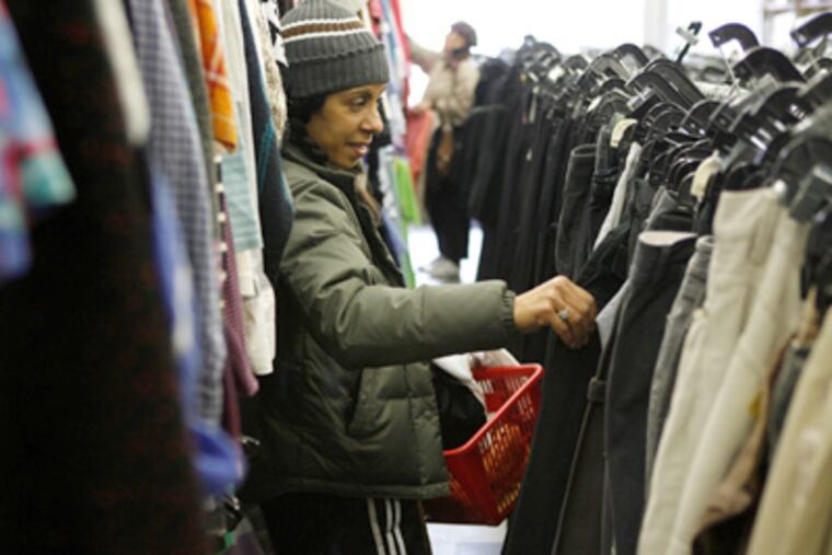 Michelle Dejean shops last week at a Salvation Army in New York. By necessity - and out of fear that economic conditions could get even worse and stay that way for a while - thriftiness is making a comeback in America. (AP Photo/Seth Wenig)