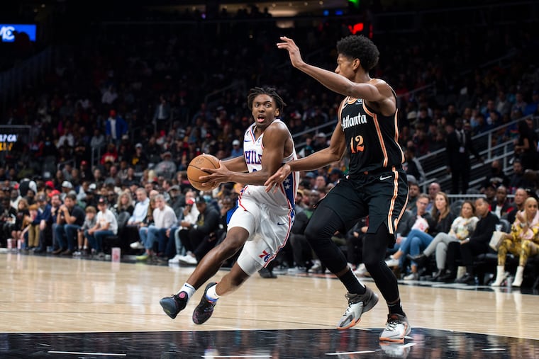 Philadelphia 76ers' Tyrese Maxey drives against Atlanta Hawks' De'Andre Hunter during the second half of an NBA basketball game Thursday, Nov. 10, 2022, in Atlanta. (AP Photo/Hakim Wright Sr.)