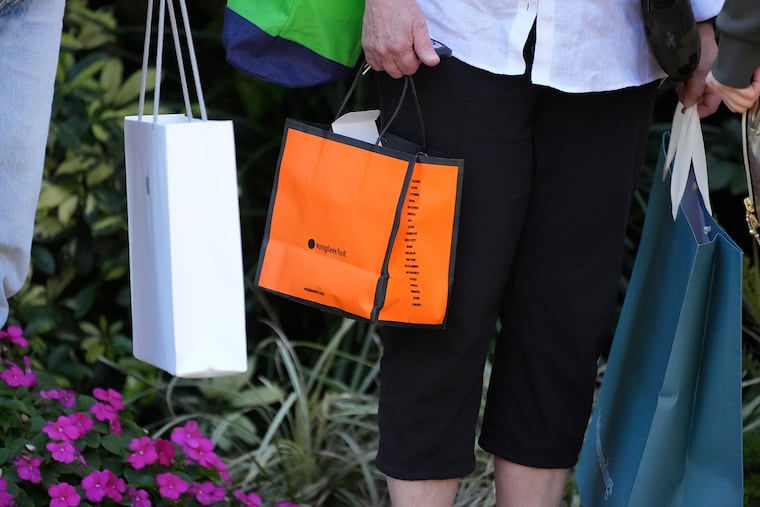 Shoppers carry their purchases in Bradenton, Fla., in February.