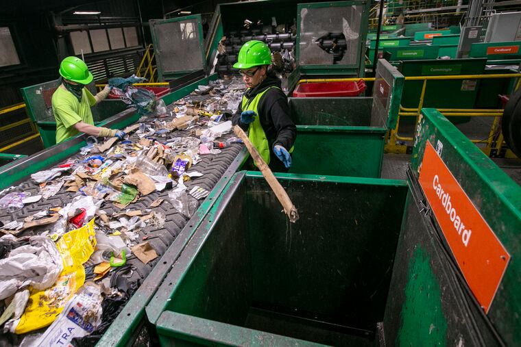Isaiah Mayne and Rose Valentine (right) sort materials at the TotalRecycle plant in Birdsboro, Berks County.
