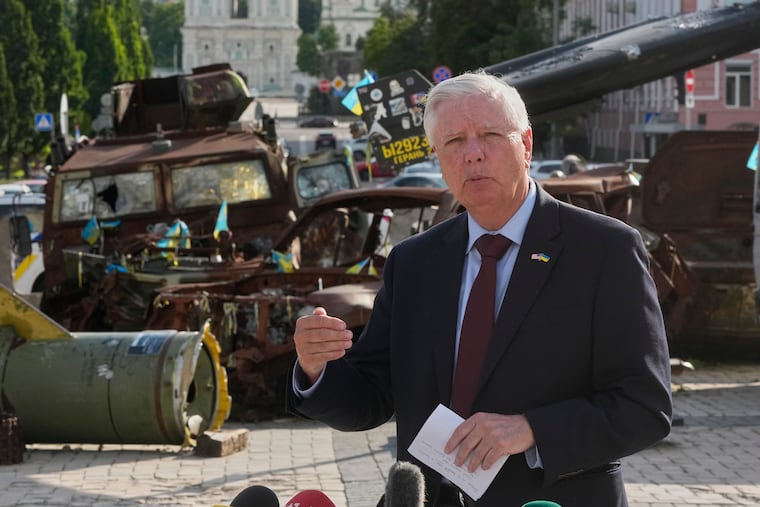 Sen. Lindsey Graham (R., S.C.) answers questions Friday near damaged Russian vehicles exhibition in central Kyiv, Ukraine.