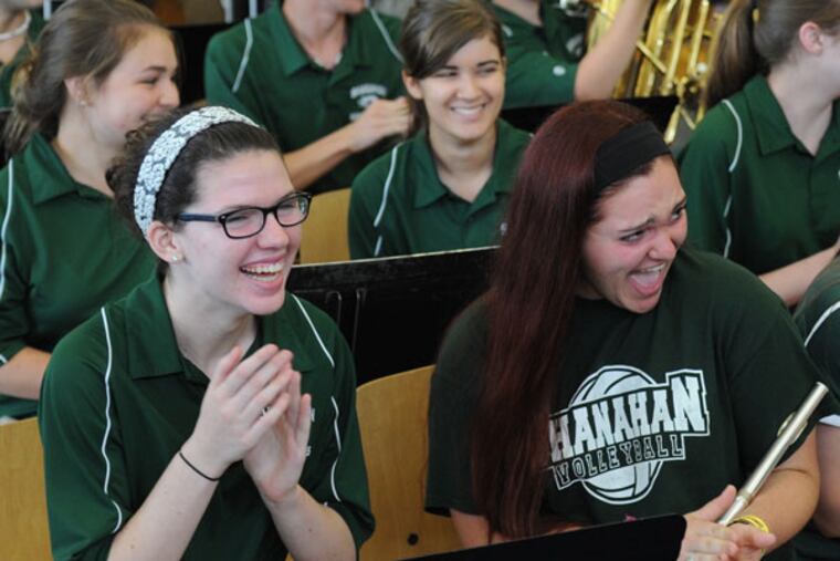 Bishop Shanahan High School band members Kristen Loughlin (left), a junior picalo player, and Emma Byler, a senior flute player, react excitedly as theylearned Sunday that they will be playing for Pope Francis as he arrives at Philadelphia International Airport for the World Meeting of Families in late September. (CLEM MURRAY / Staff Photographer)